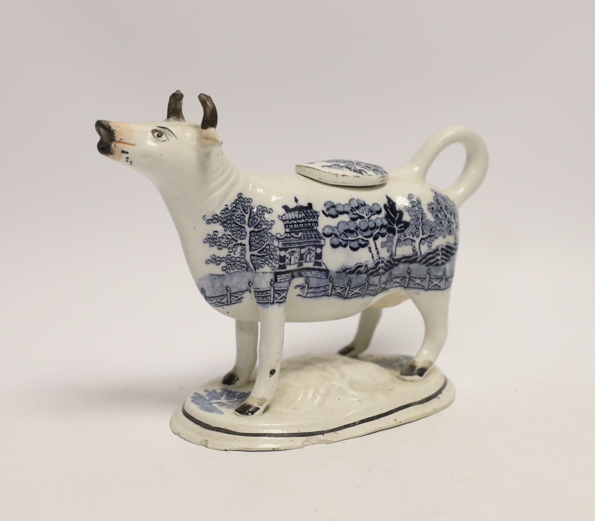 A 19th century Staffordshire porcellaneous willow pattern cow creamer, 18cm wide